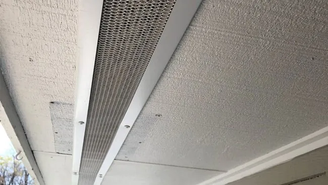Mesh guard installed along the underside of a roof overhang