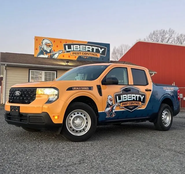 Liberty Pest Control truck parked outside the Paducah office under the Liberty sign
