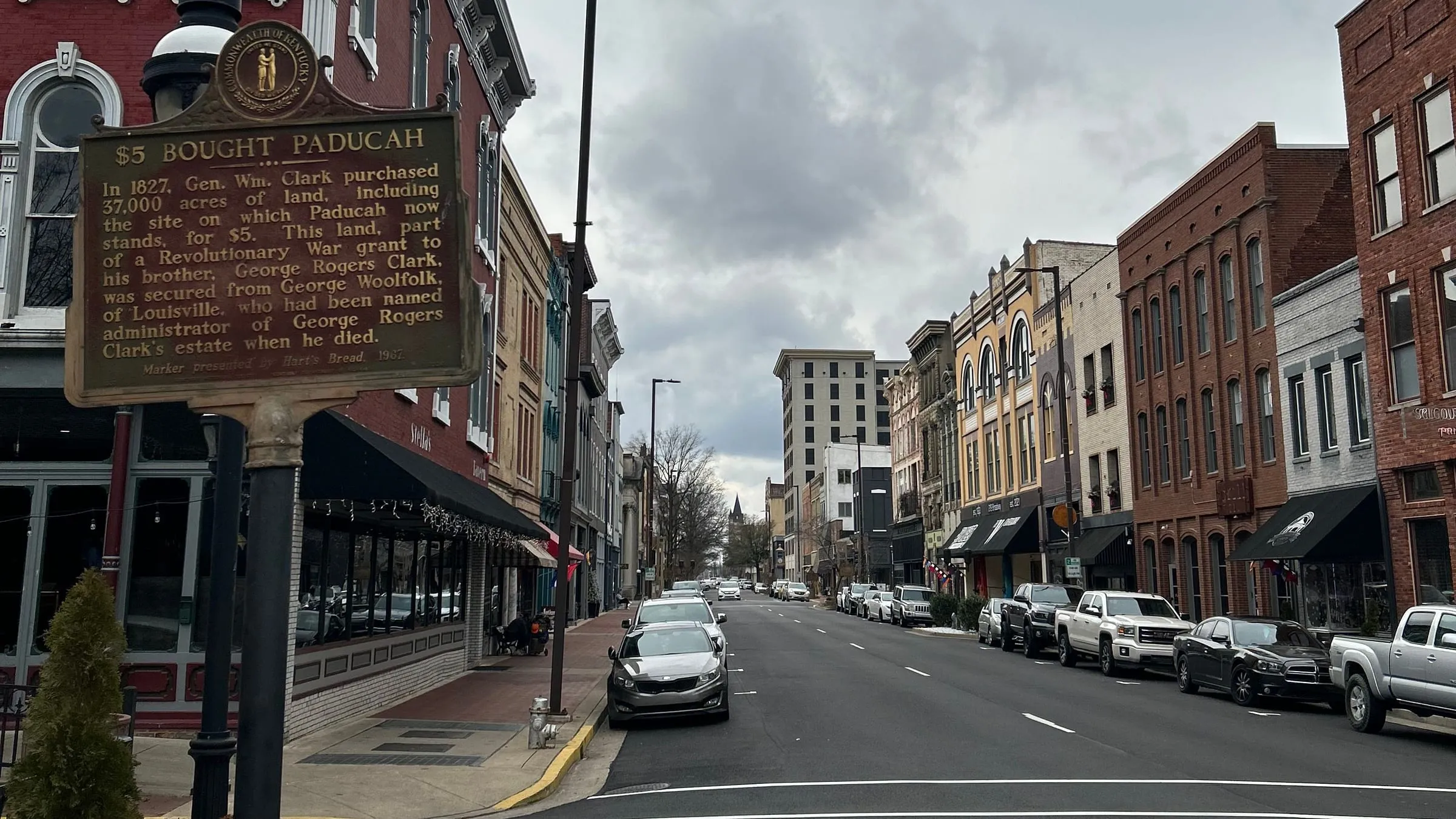 Downtown Paducah storefronts beside a Kentucky historical marker