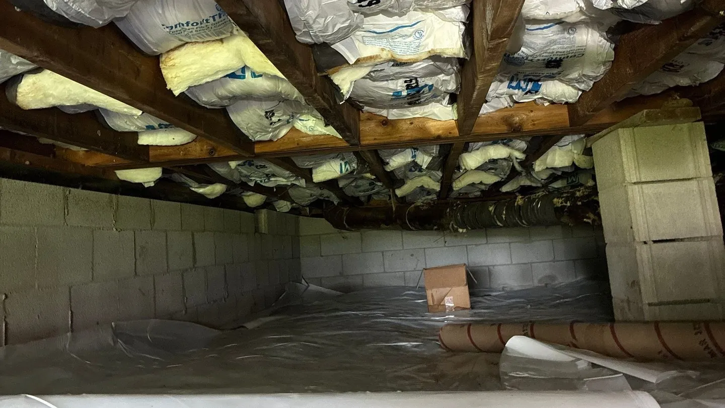 Insulation installed between the floor joists above a crawlspace