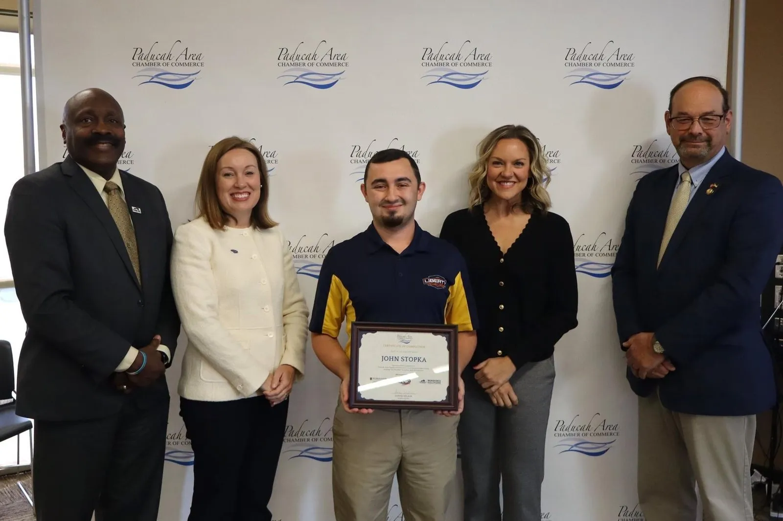 John Stopka holding his Small Business Cohort certificate of completion at the Paducah Area Chamber of Commerce